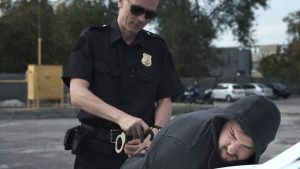 A cop arresting a man